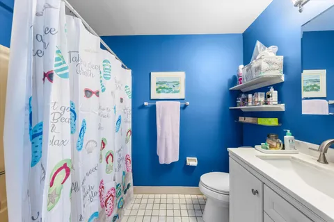 a bathroom with a sink mirror vanity and toilet