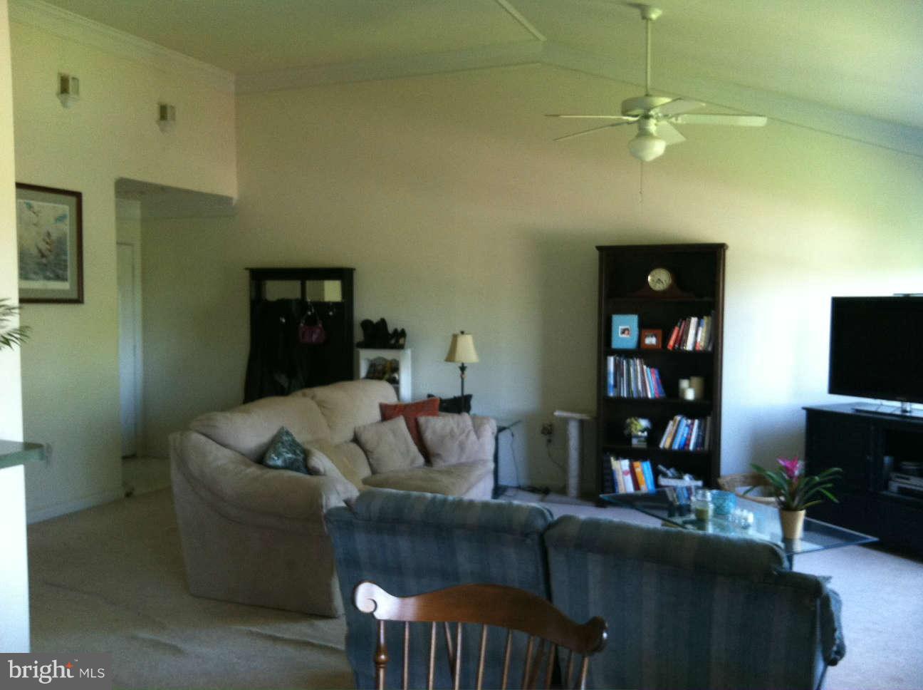 413 Merganser Court, Unit G Chester, MD 21619 - Photo 11 of 12 a living room with furniture and a flat screen tv