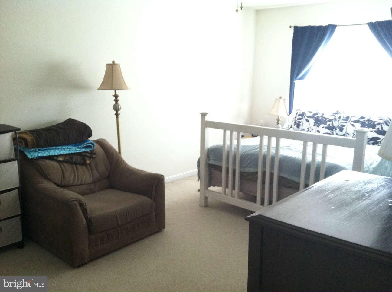413 Merganser Court, Unit G Chester, MD 21619 - Photo 9 of 12 a living room with furniture and a floor to ceiling window