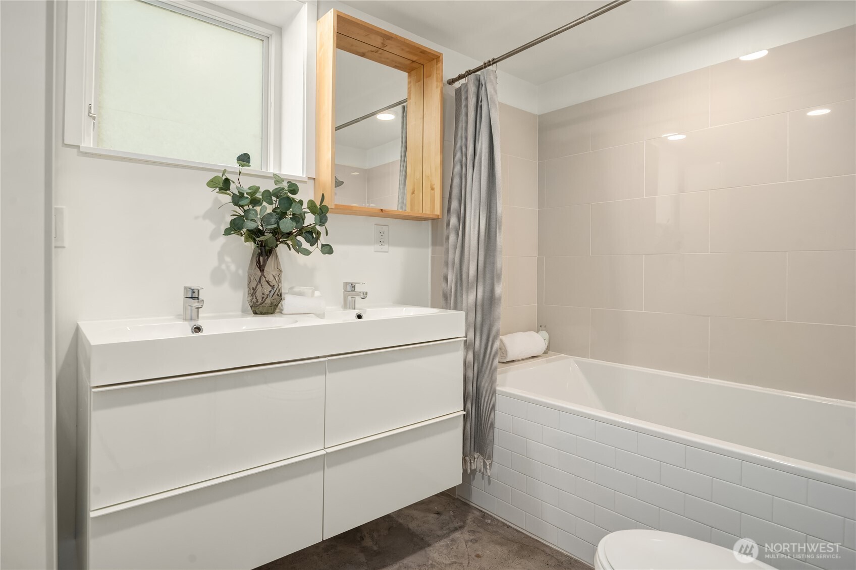 5648 38th Avenue Southwest Seattle, WA 98126 - Photo 19 of 40 a bathroom with a sink and a bathtub