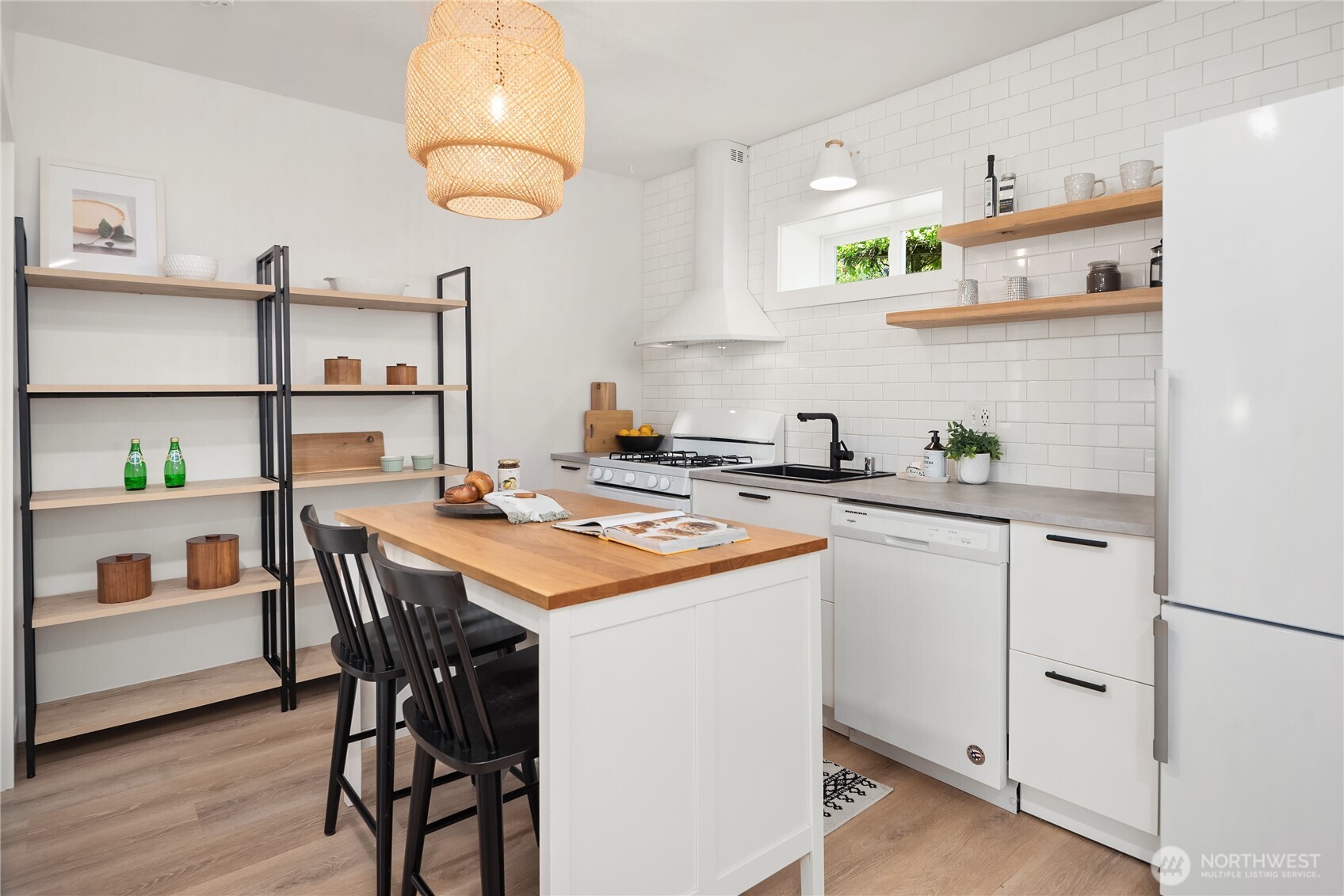 5648 38th Avenue Southwest Seattle, WA 98126 - Photo 30 of 40 a kitchen with a table chairs stove and cabinets