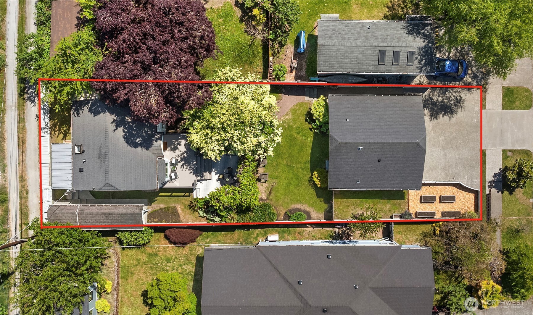 5648 38th Avenue Southwest Seattle, WA 98126 - Photo 3 of 40 an aerial view of a house with a yard and large trees