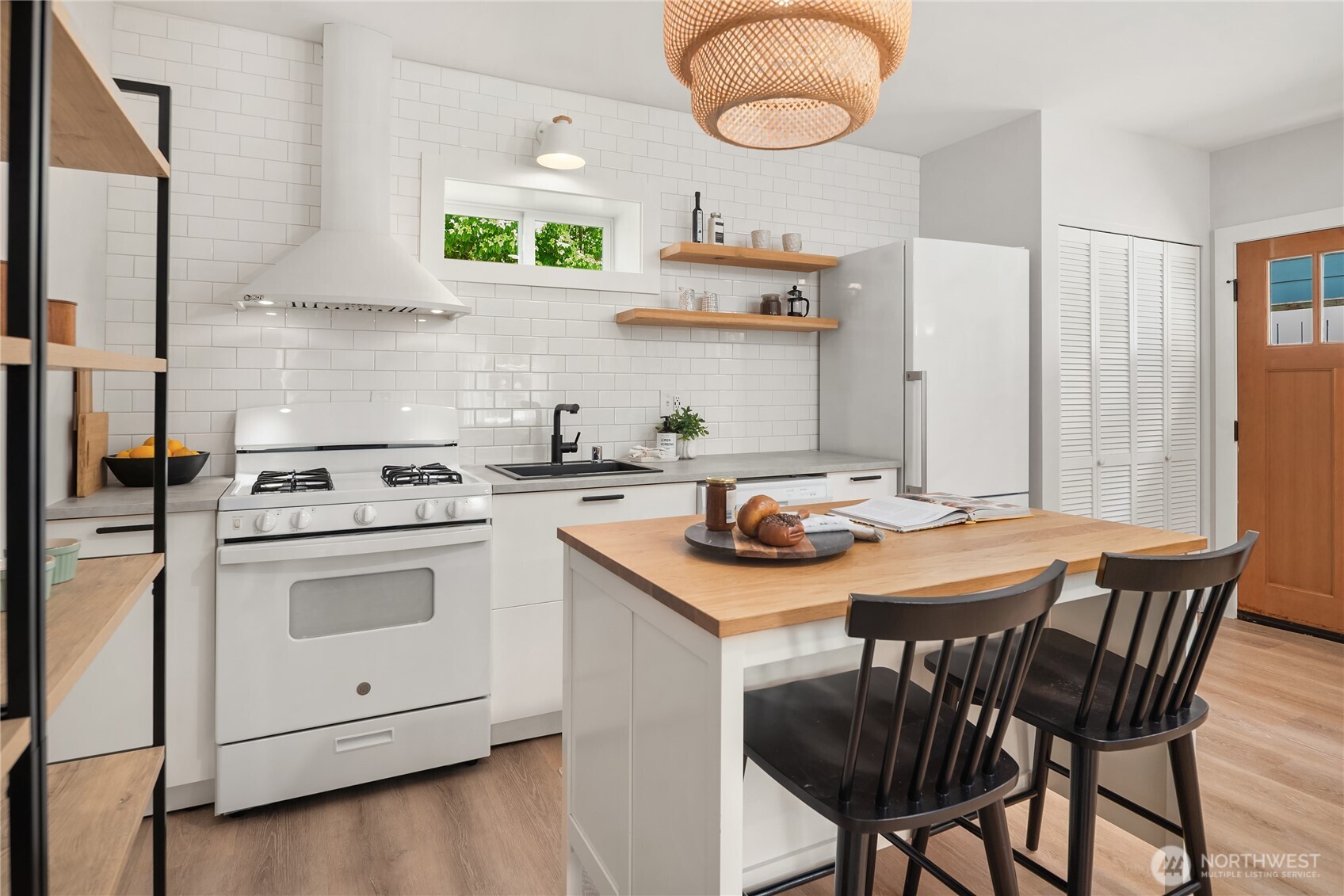 5648 38th Avenue Southwest Seattle, WA 98126 - Photo 31 of 40 a kitchen with a stove a sink and a refrigerator