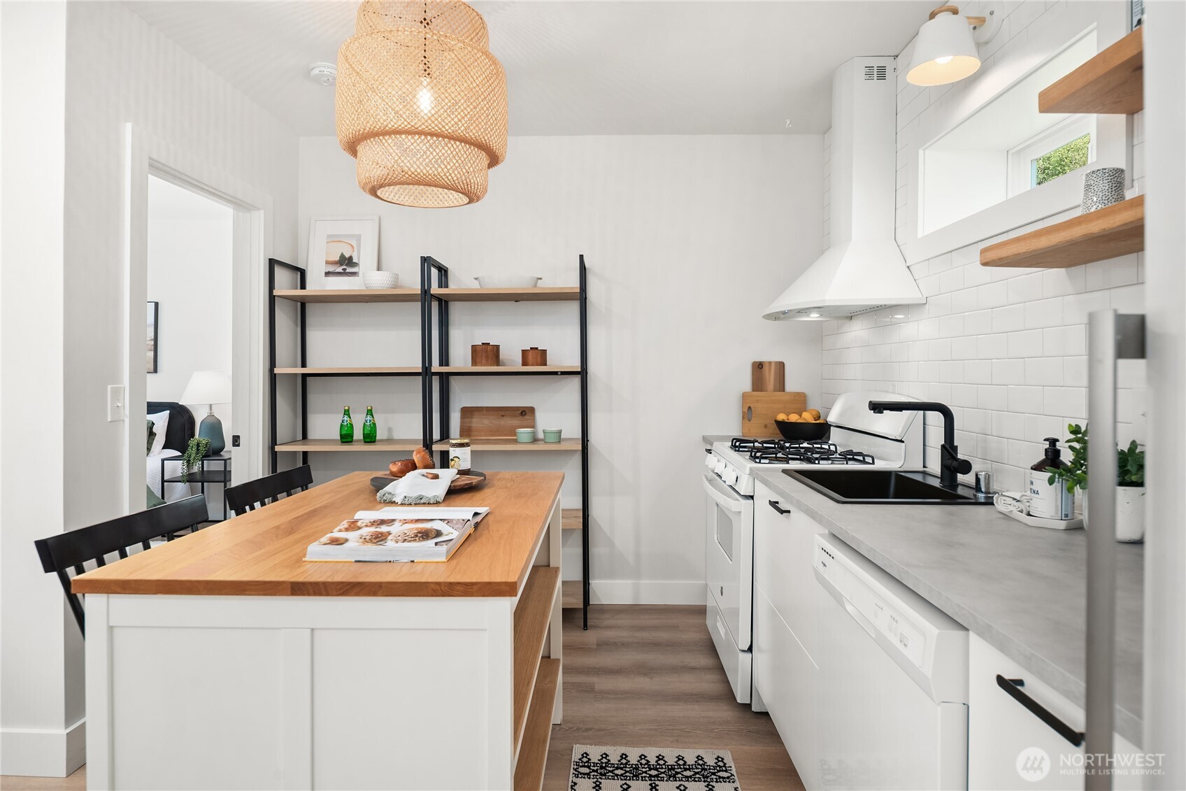 5648 38th Avenue Southwest Seattle, WA 98126 - Photo 32 of 40 a kitchen with stainless steel appliances kitchen island granite countertop a sink a stove and a wooden floors