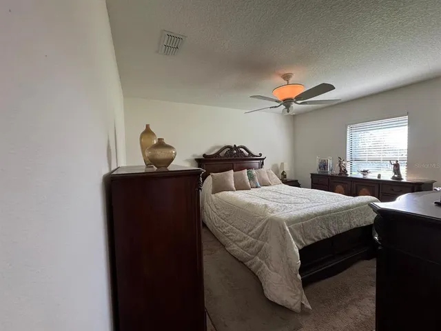 a bedroom with bed and a chandelier