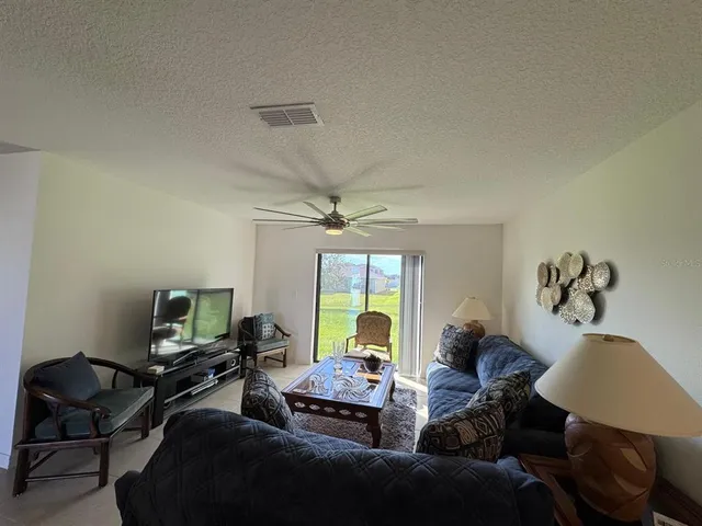 a kitchen with a refrigerator a sink and wooden cabinets