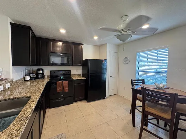 a kitchen with a refrigerator and a sink