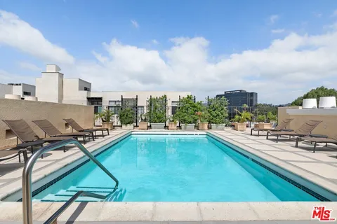 a view of a swimming pool and lounge chair