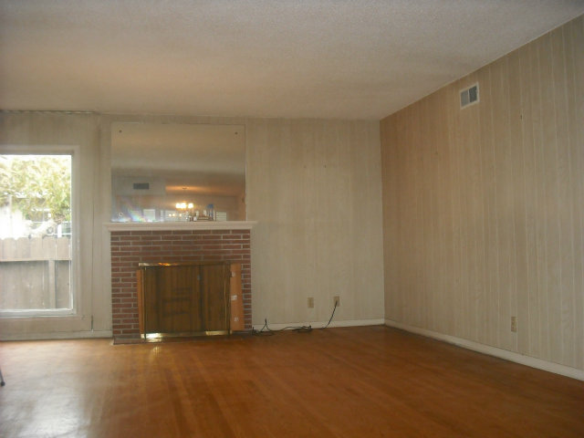423 Dwight Road Burlingame, CA 94010 - Photo 7 of 11 an empty room with fireplace and windows