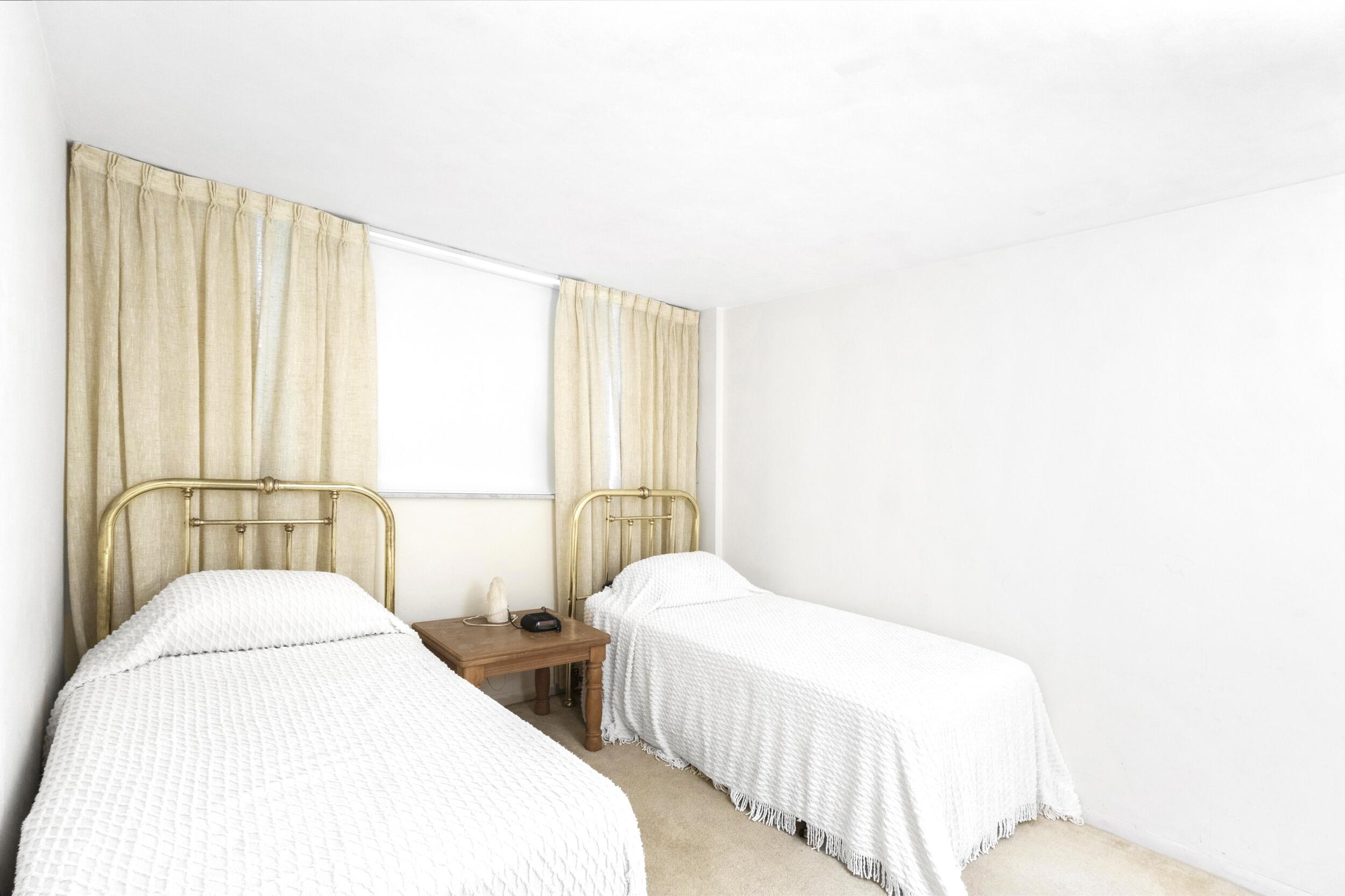 4500 North Federal Highway, Unit 272H Lighthouse Point, FL 33064 - Photo 11 of 30 a bedroom with a bed and a window