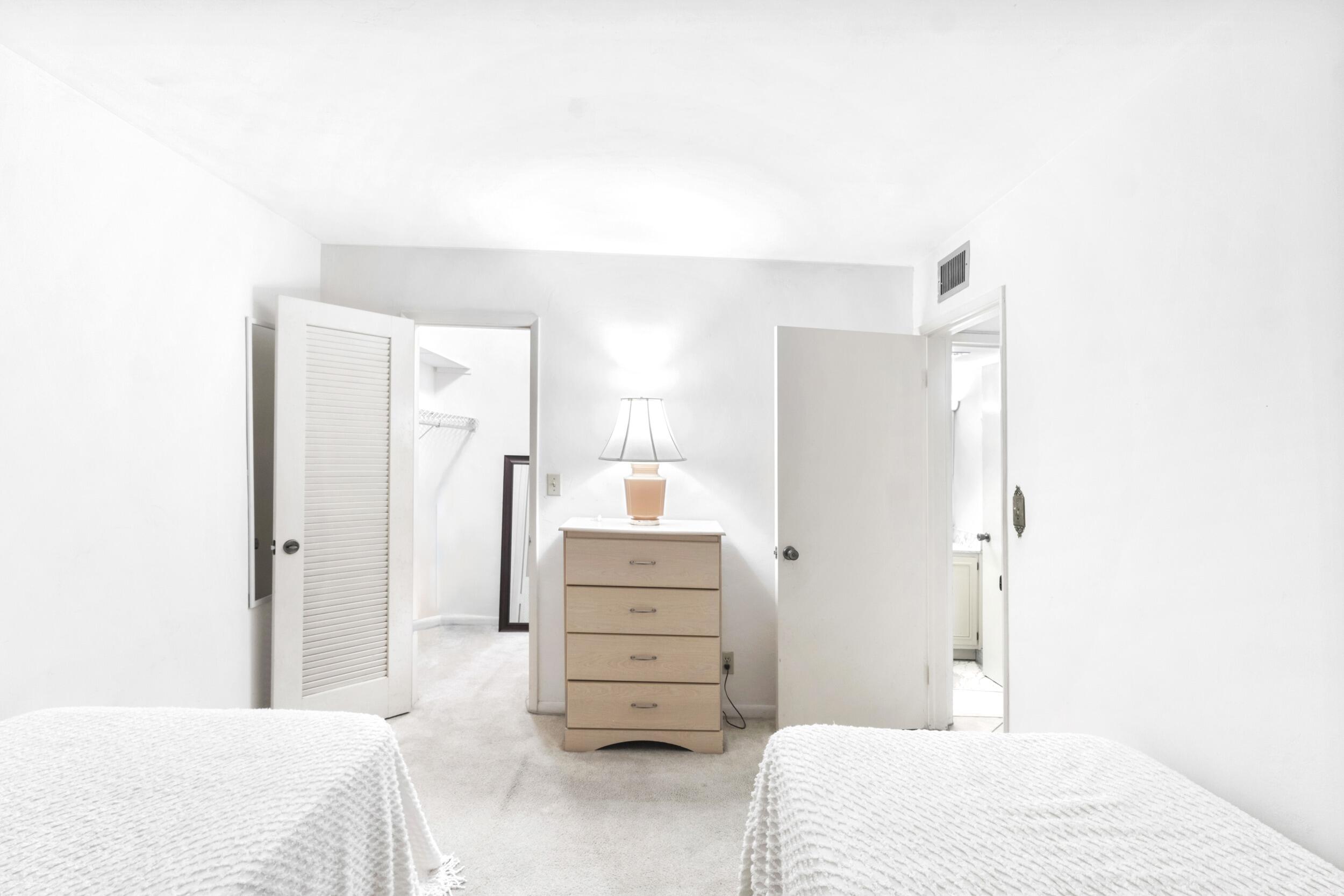 4500 North Federal Highway, Unit 272H Lighthouse Point, FL 33064 - Photo 12 of 30 a bedroom with a bed and dresser