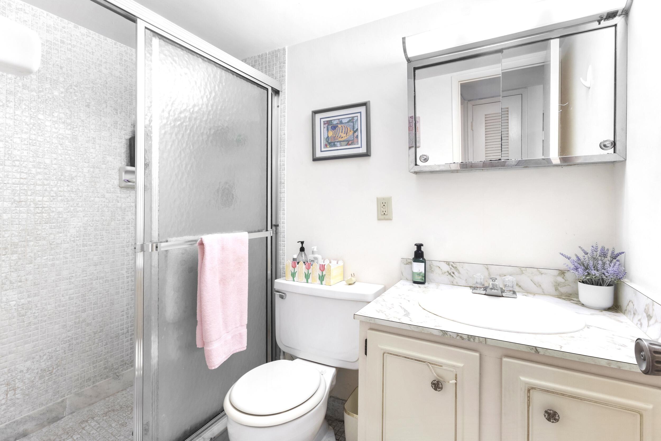 4500 North Federal Highway, Unit 272H Lighthouse Point, FL 33064 - Photo 13 of 30 a bathroom with a sink toilet and shower