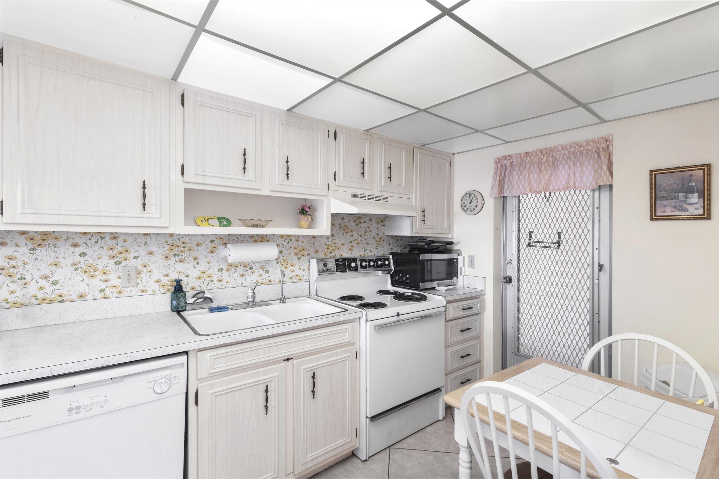 4500 North Federal Highway, Unit 272H Lighthouse Point, FL 33064 - Photo 5 of 30 a kitchen with cabinets appliances a sink and a counter top