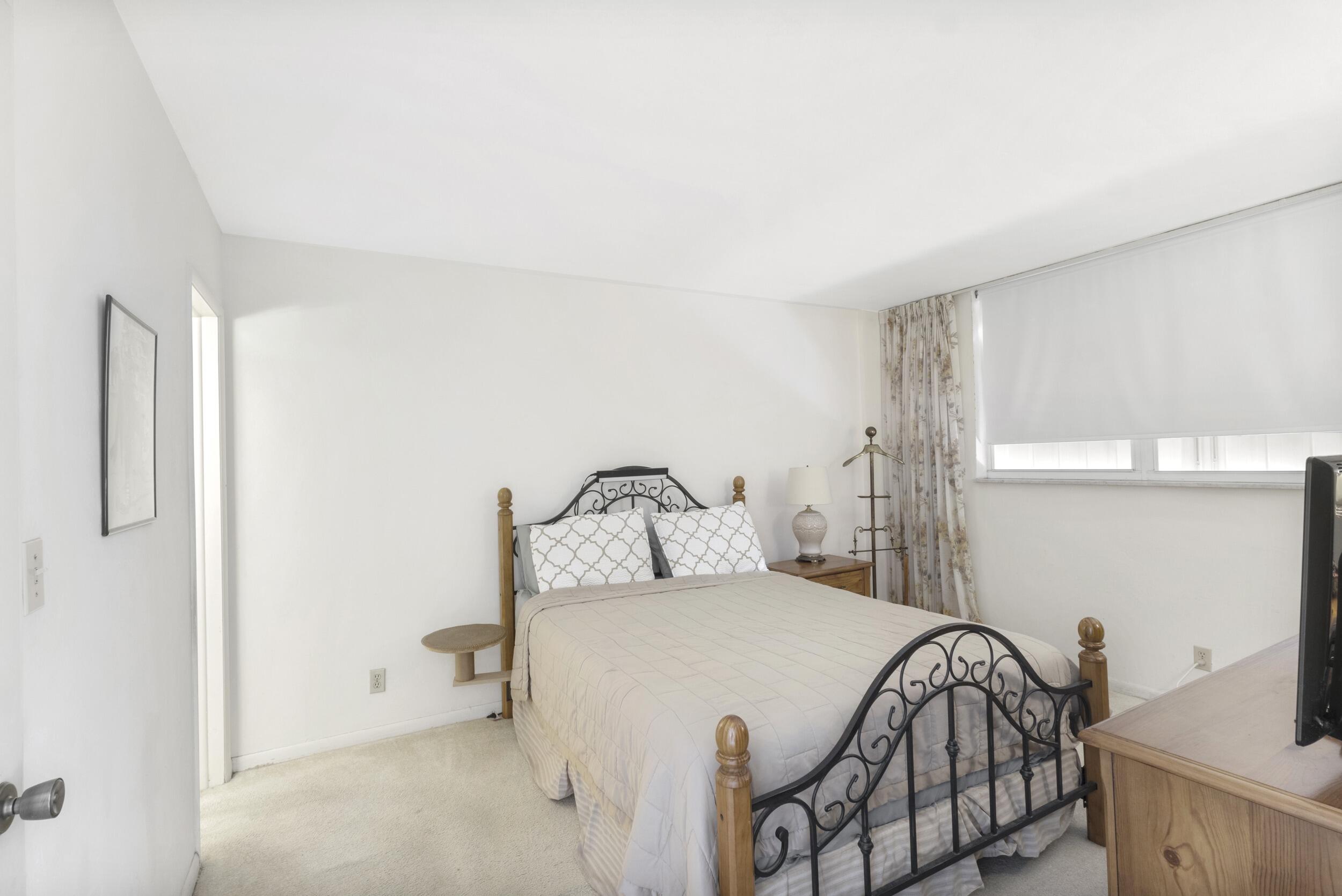 4500 North Federal Highway, Unit 272H Lighthouse Point, FL 33064 - Photo 8 of 30 a bedroom with a bed and a dresser