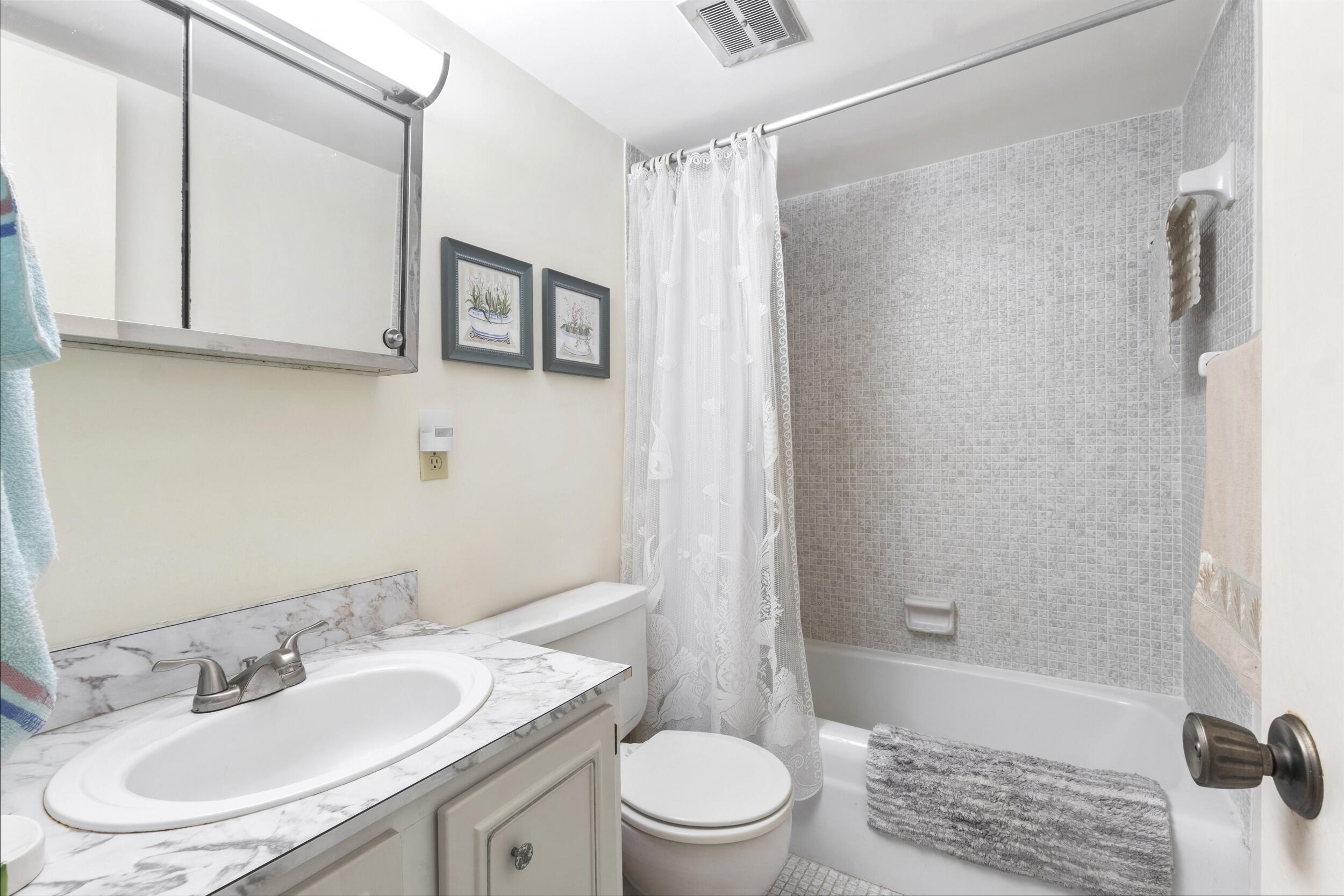 4500 North Federal Highway, Unit 272H Lighthouse Point, FL 33064 - Photo 10 of 30 a bathroom with a sink a toilet and shower