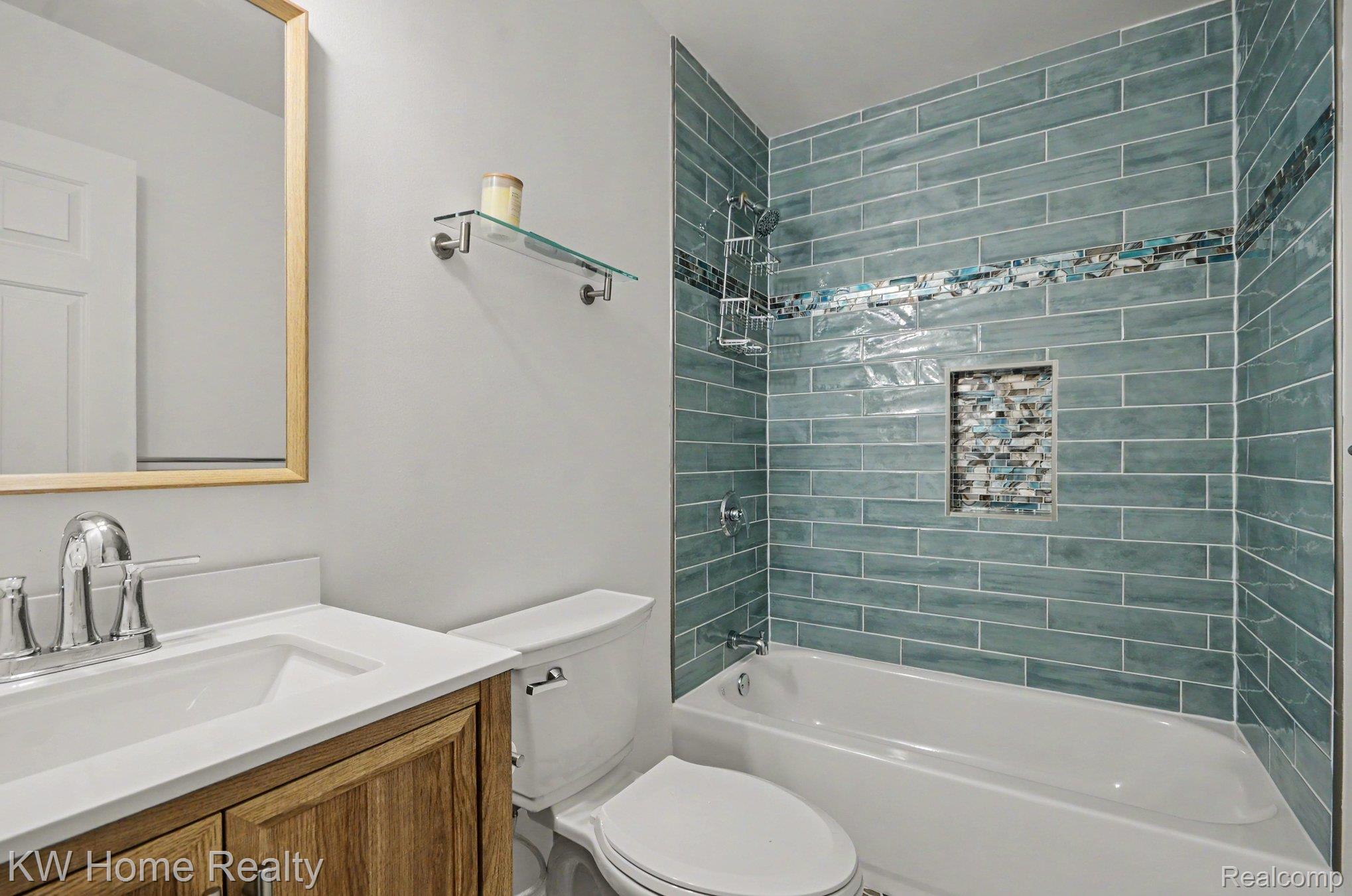 2383 East Maple Road Troy, MI 48083 - Photo 9 of 25 Bathroom featuring a single vanity with wood-finish cabinetry, a white countertop, and a rectangular sink