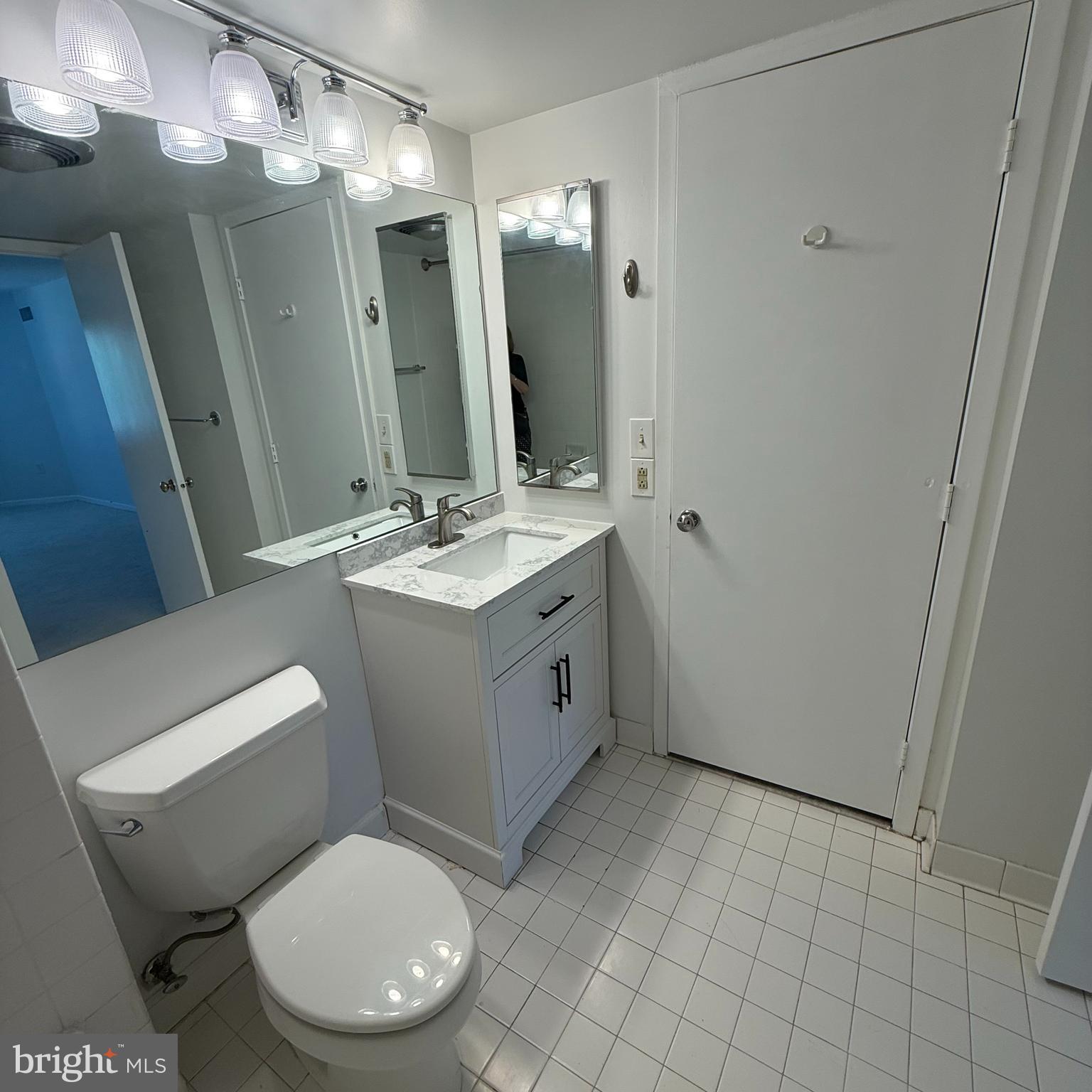 2111 Wisconsin Avenue Northwest, Unit 402 Washington, DC 20007 - Photo 14 of 22 a bathroom with a toilet sink and mirror