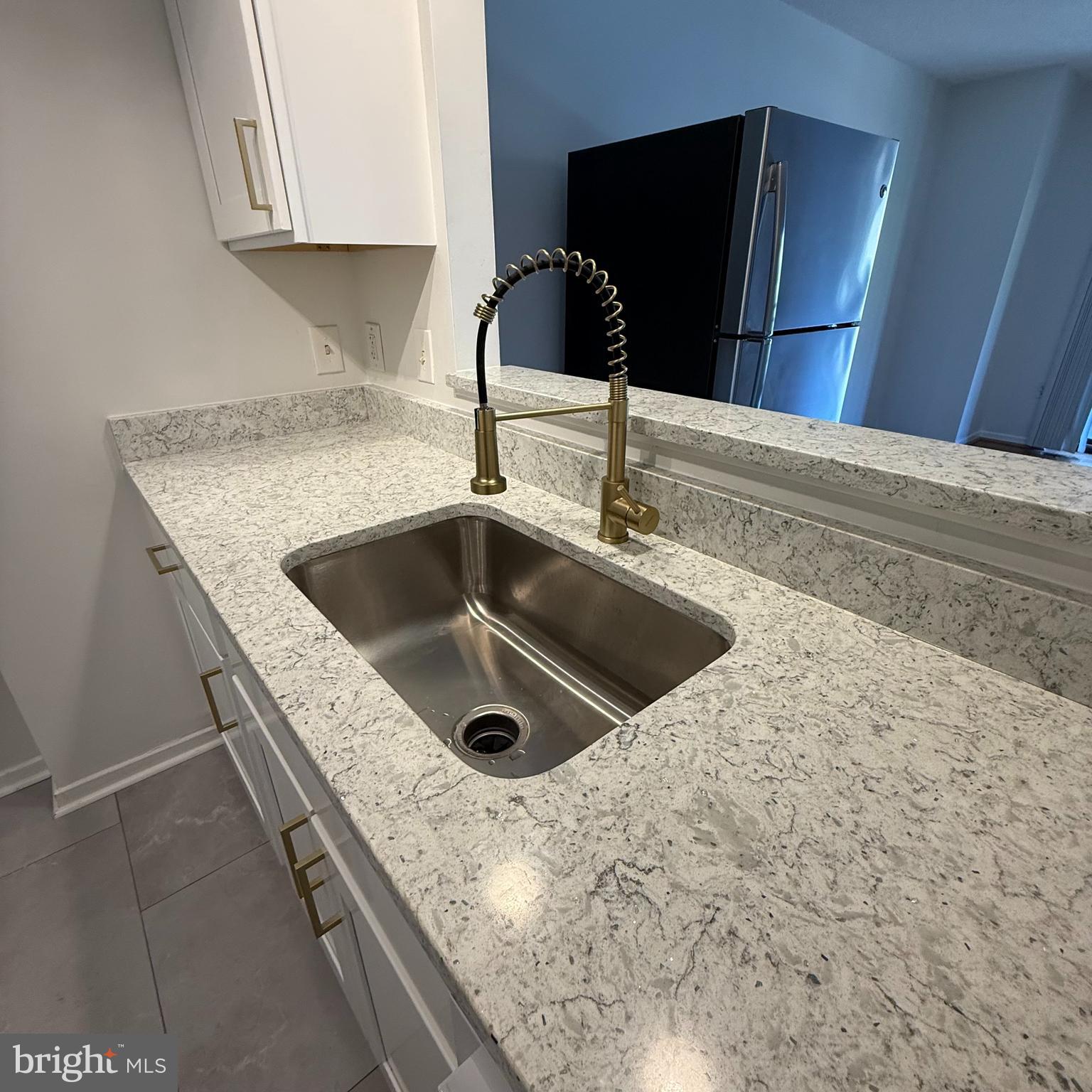 2111 Wisconsin Avenue Northwest, Unit 402 Washington, DC 20007 - Photo 6 of 22 a kitchen with a sink and a refrigerator