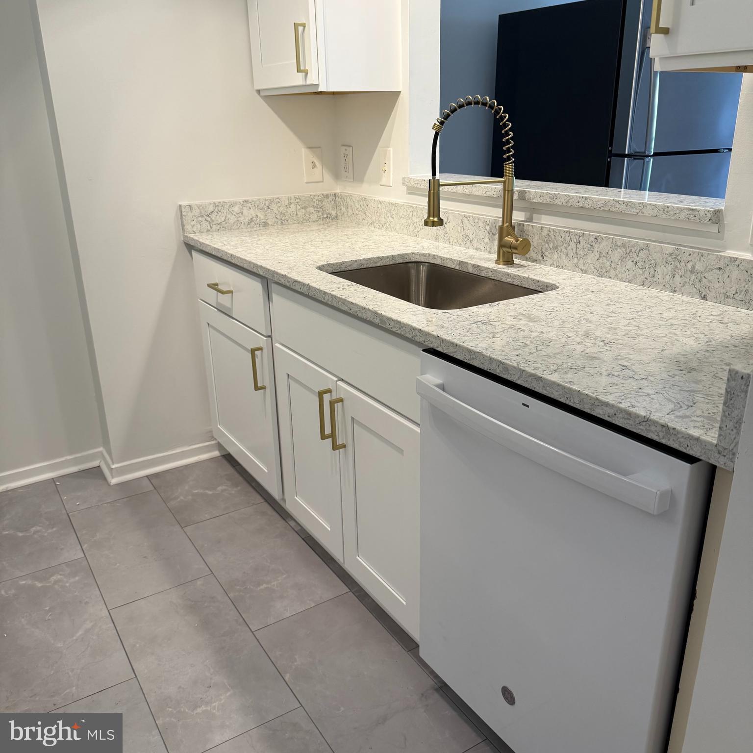 2111 Wisconsin Avenue Northwest, Unit 402 Washington, DC 20007 - Photo 7 of 22 a kitchen with a sink and cabinets