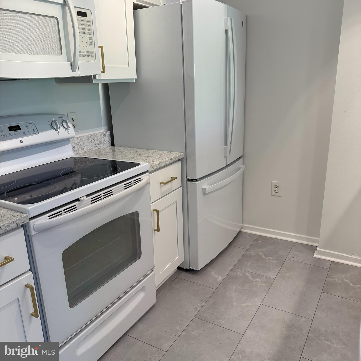 2111 Wisconsin Avenue Northwest, Unit 402 Washington, DC 20007 - Photo 8 of 22 a kitchen with white cabinets and white appliances