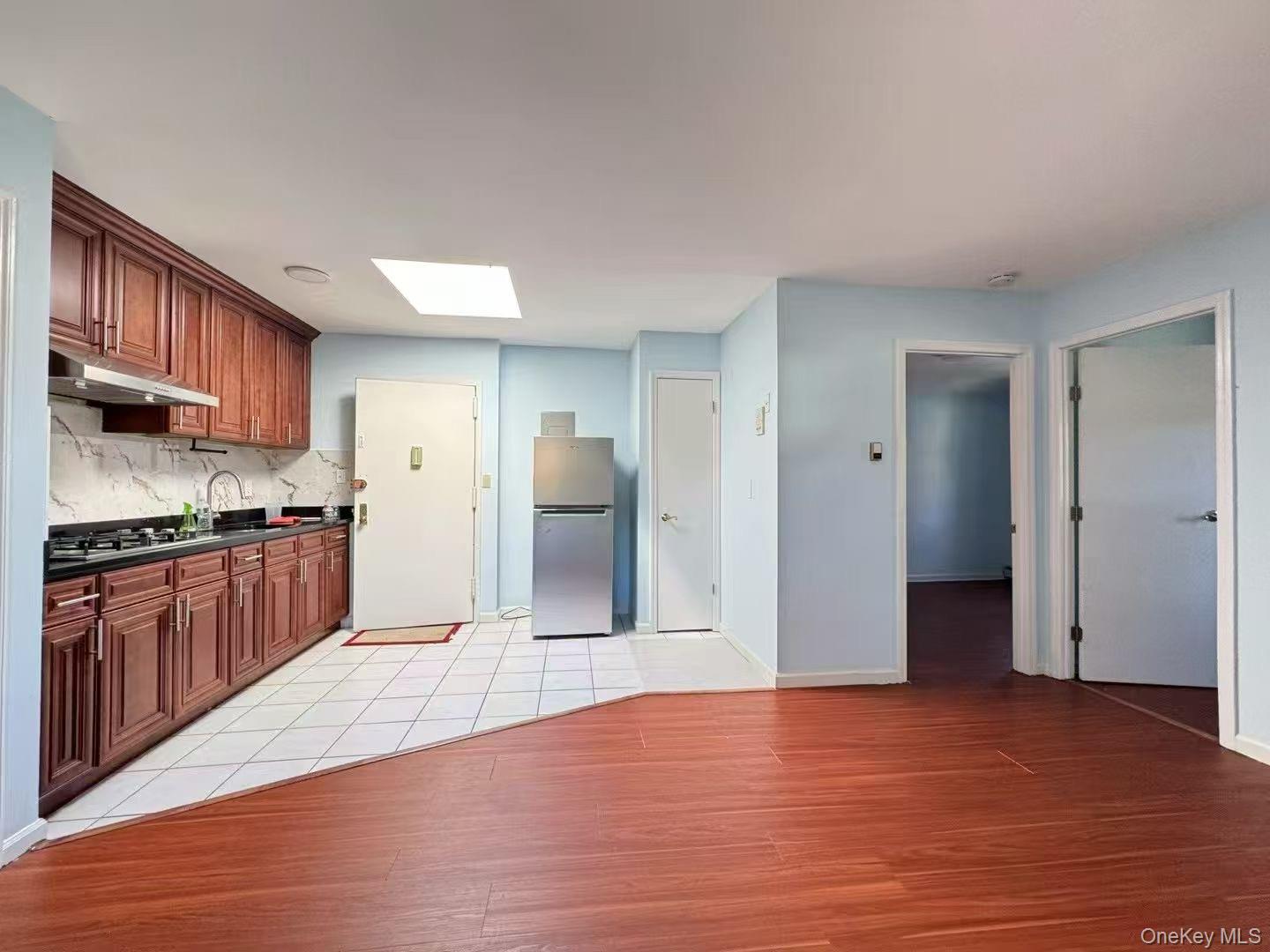a kitchen with stainless steel appliances granite countertop a refrigerator and a sink