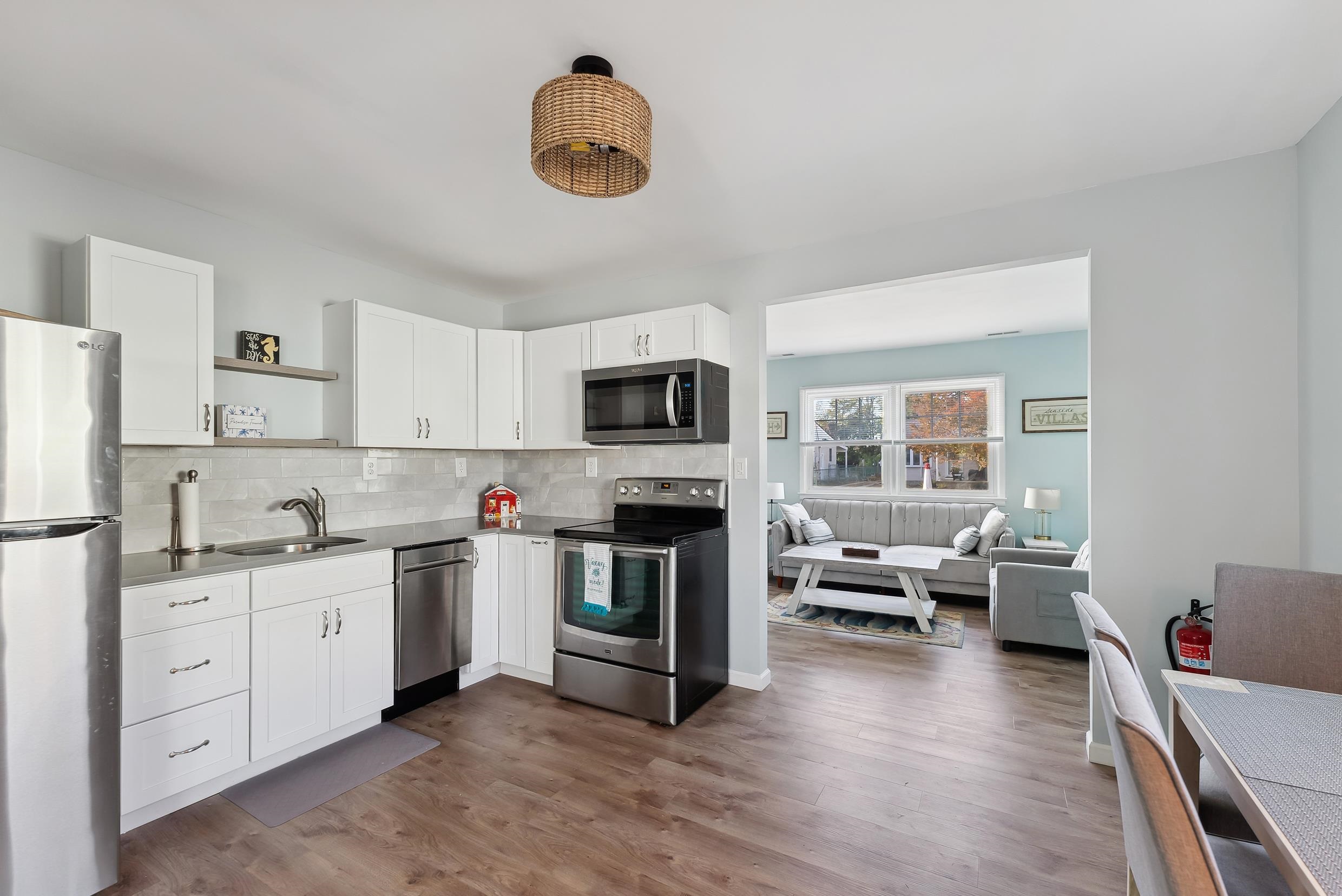 127 Broadway Villas, NJ 08251 - Photo 2 of 30 a kitchen with a sink dishwasher a stove and a refrigerator with wooden floor