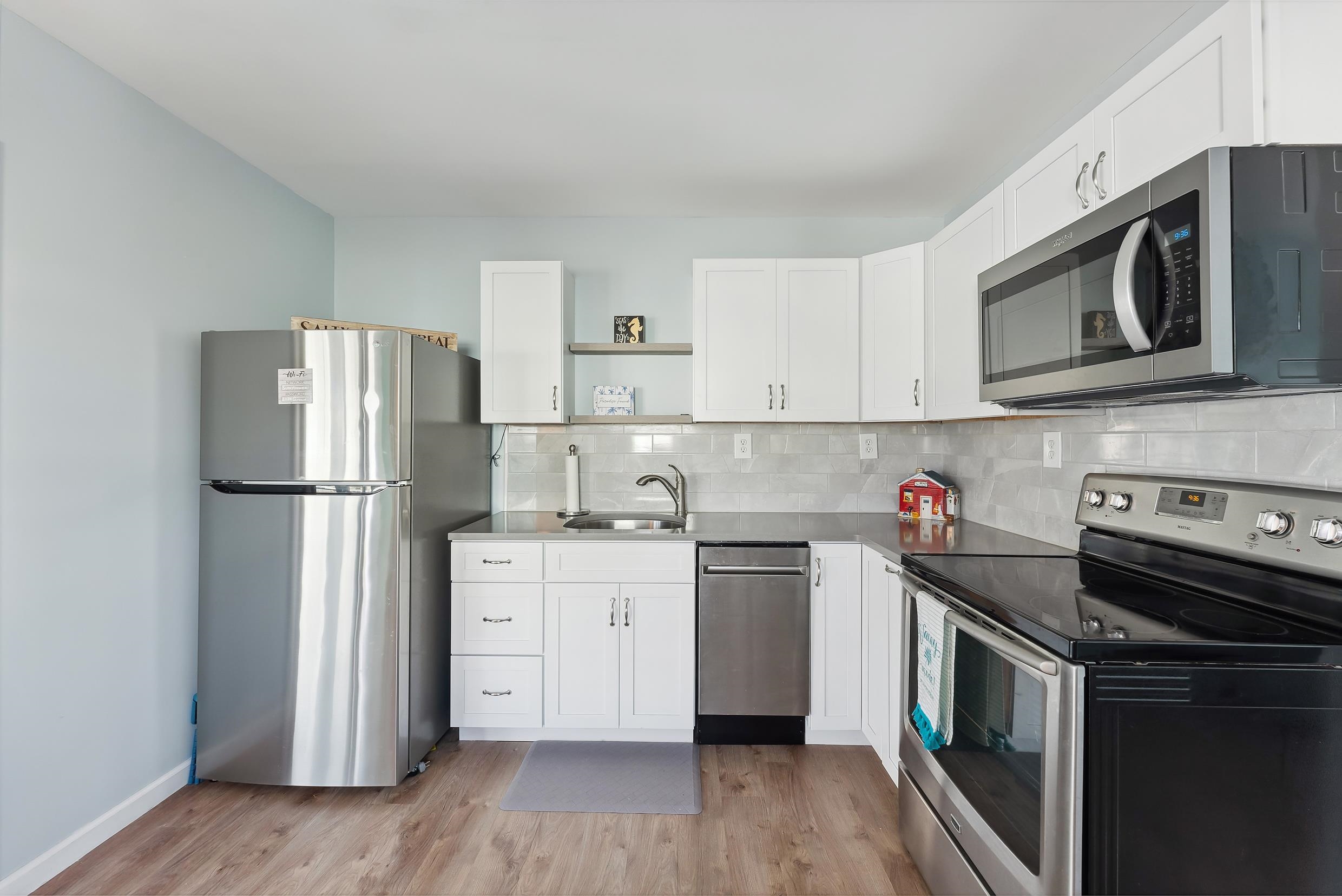 127 Broadway Villas, NJ 08251 - Photo 5 of 30 a kitchen with a stove top oven a refrigerator and cabinets