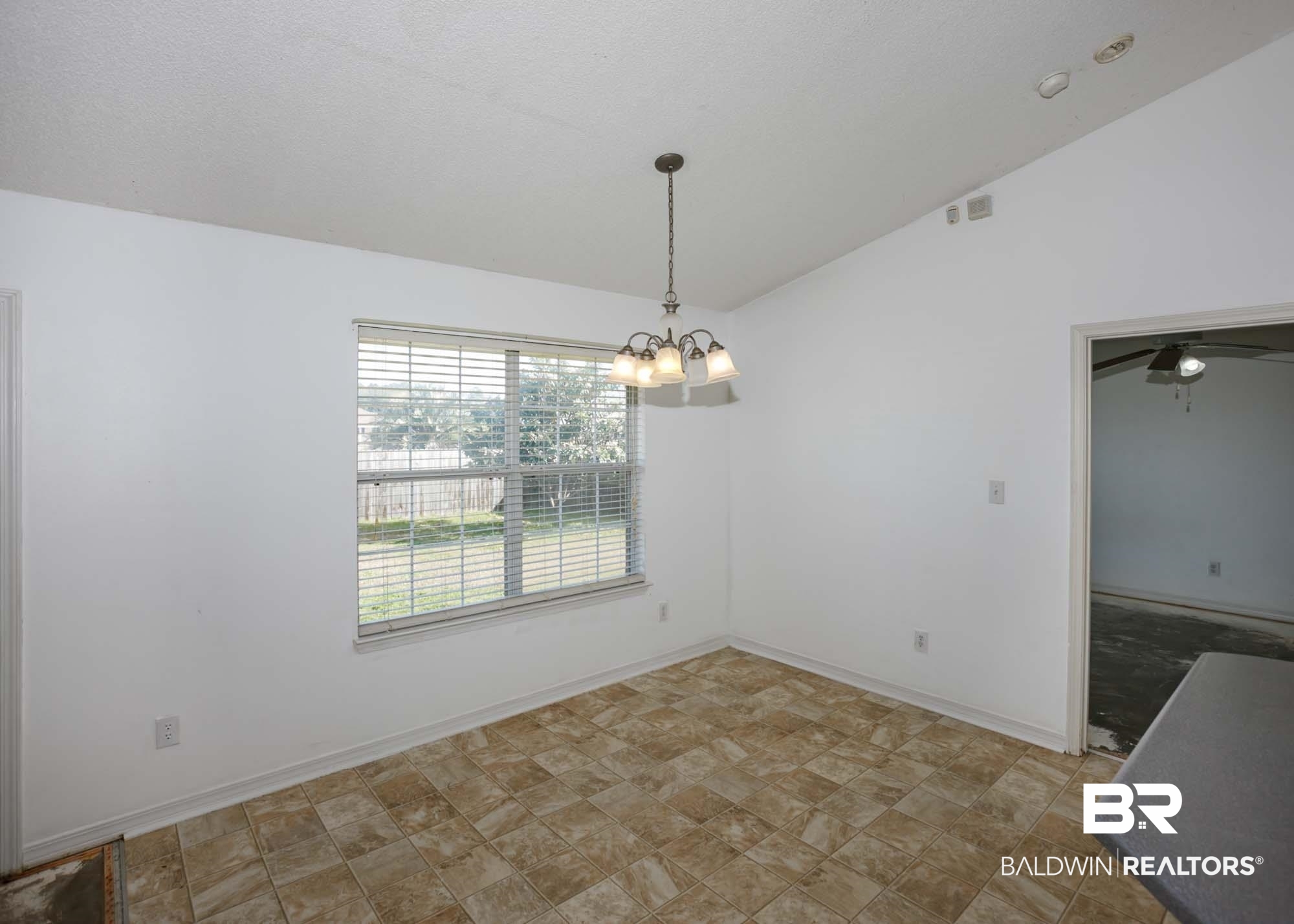 2530 Ashburn Lane Foley, AL 36535 - Photo 12 of 46 Unfurnished dining area with ceiling fan with notable chandelier and vaulted ceiling