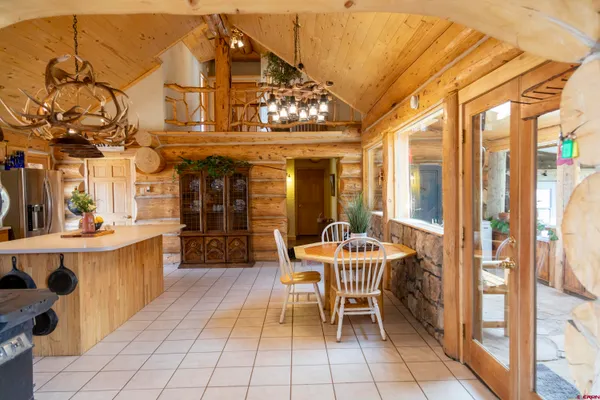 a dining room with furniture and a chandelier
