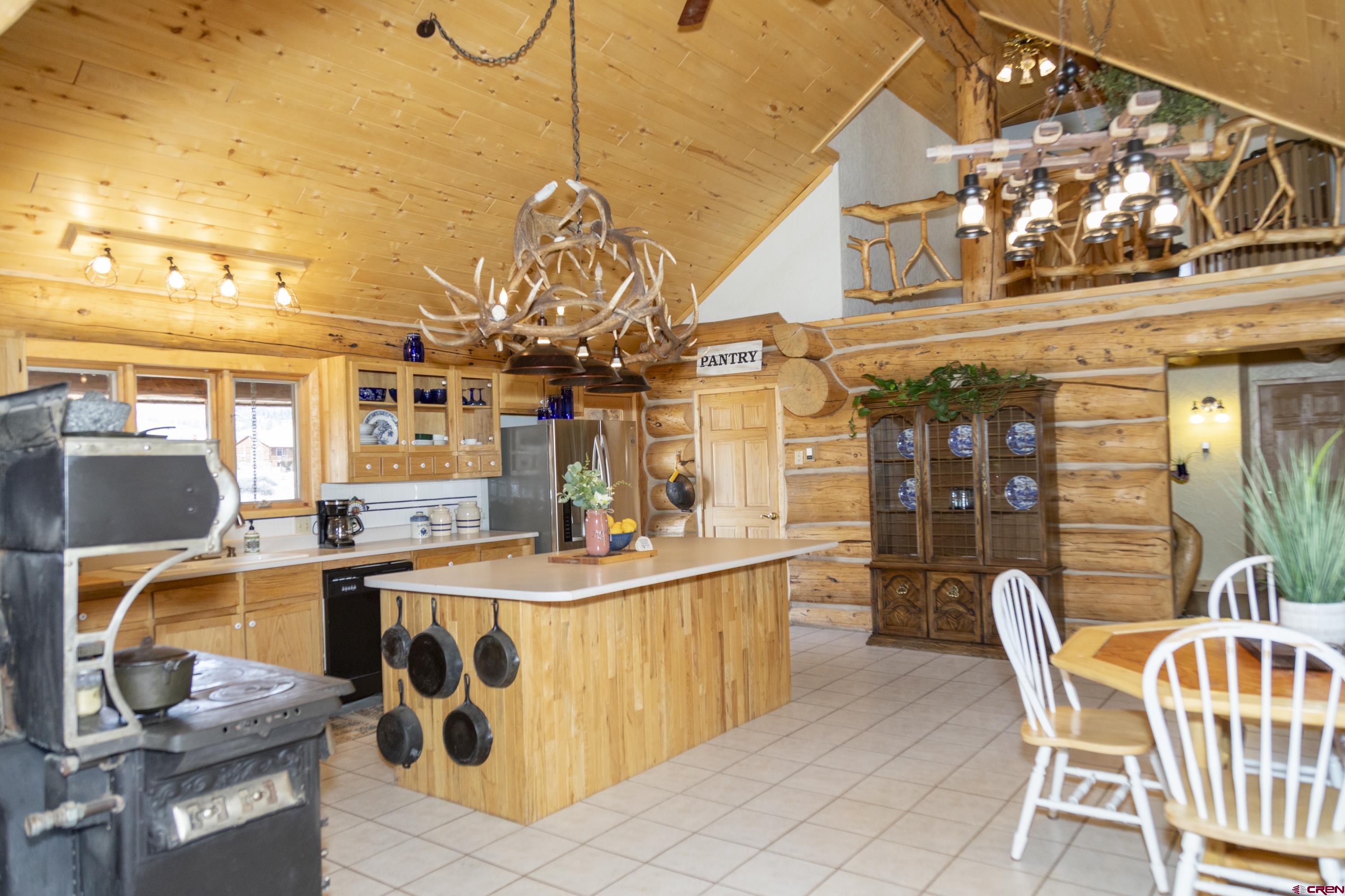108 Forest Road Creede, CO 81130 - Photo 11 of 32 a view of a kitchen with a dining table and chairs