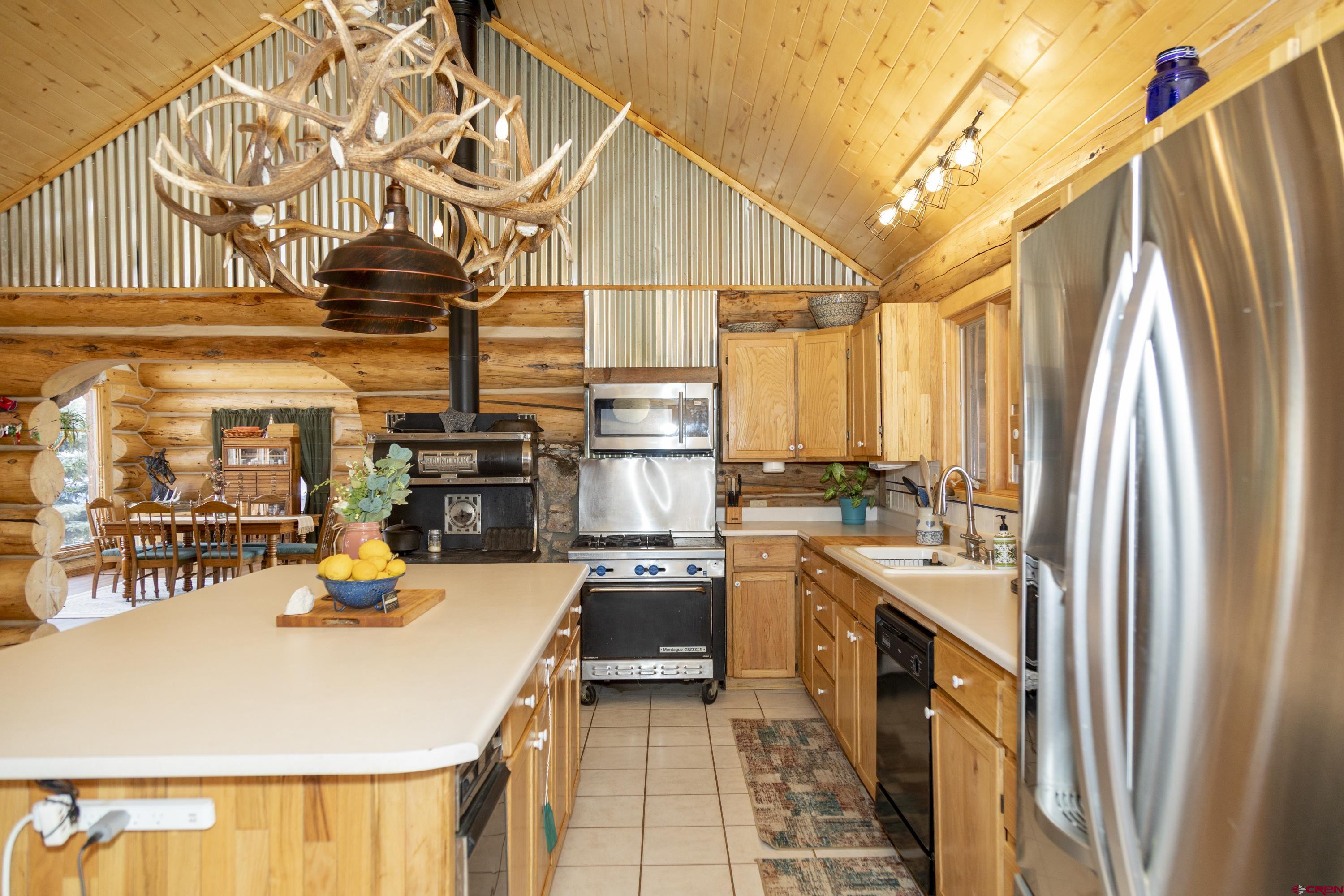 108 Forest Road Creede, CO 81130 - Photo 12 of 32 a kitchen with a sink a stove and cabinets