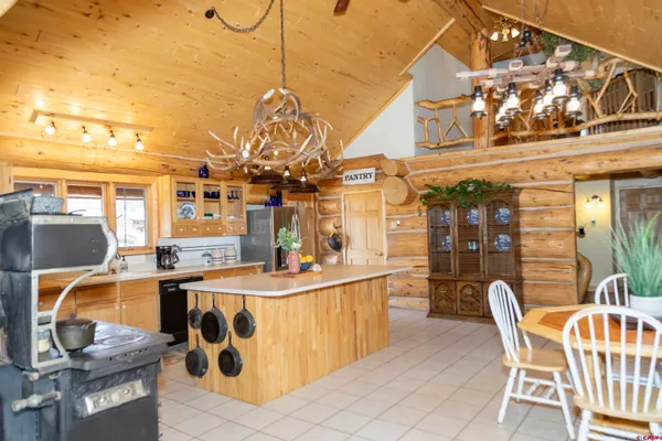 a view of a kitchen with a dining table and chairs