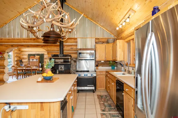 a kitchen with a sink a stove and cabinets
