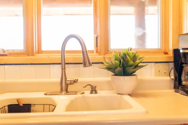 a bathroom with a tub and a large window