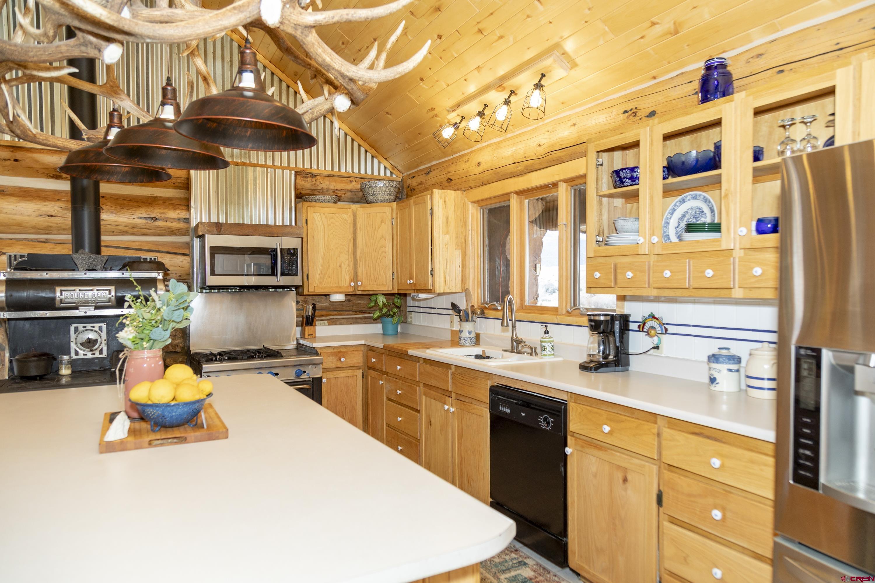108 Forest Road Creede, CO 81130 - Photo 14 of 32 a kitchen with a sink a stove and cabinets