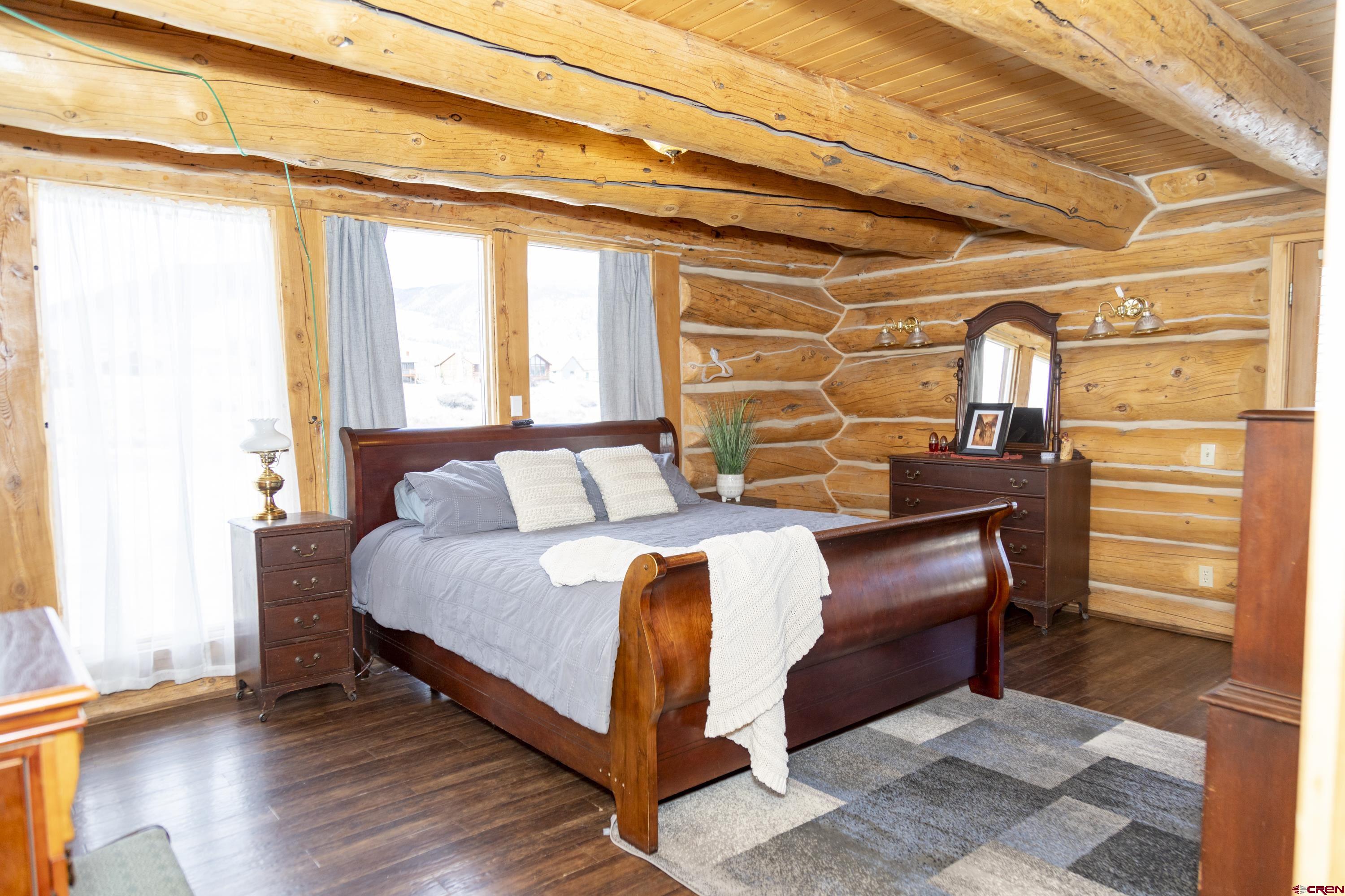 108 Forest Road Creede, CO 81130 - Photo 15 of 32 a bed sitting in a bedroom next to a window