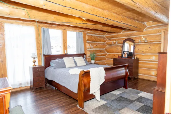 a bed sitting in a bedroom next to a window