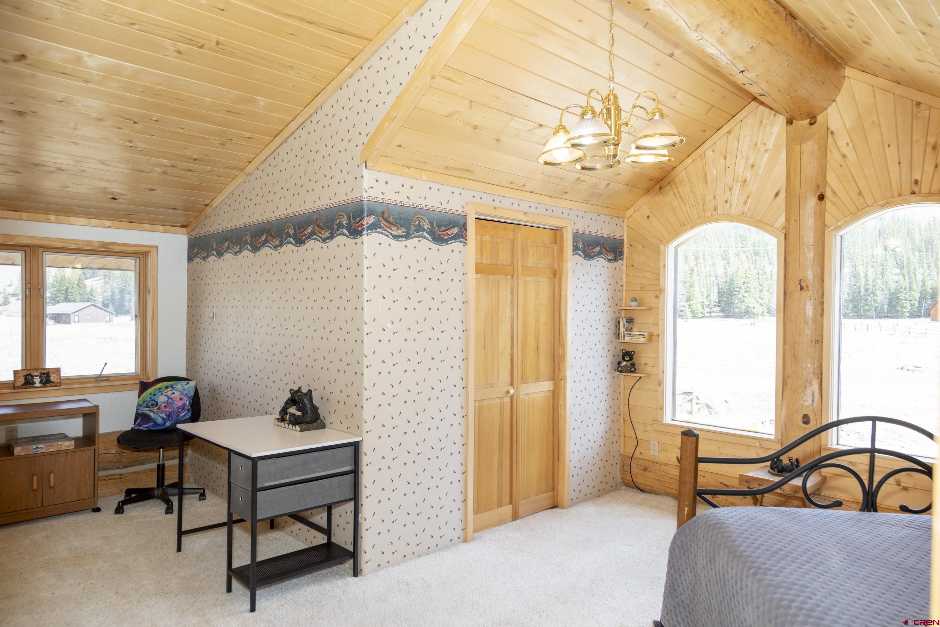 108 Forest Road Creede, CO 81130 - Photo 22 of 32 a bedroom with furniture and a window