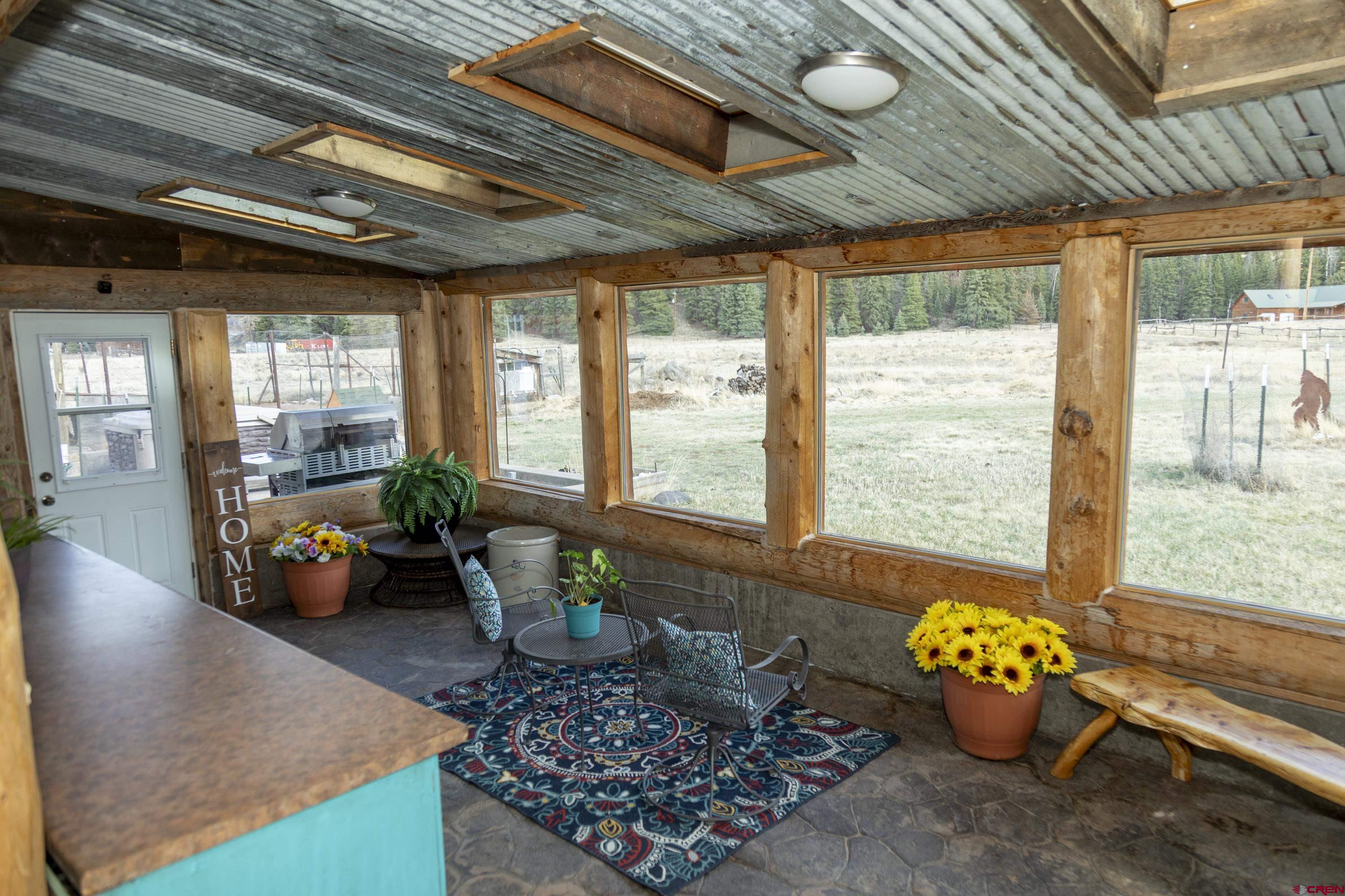 108 Forest Road Creede, CO 81130 - Photo 23 of 32 a lobby with furniture and floor to ceiling window