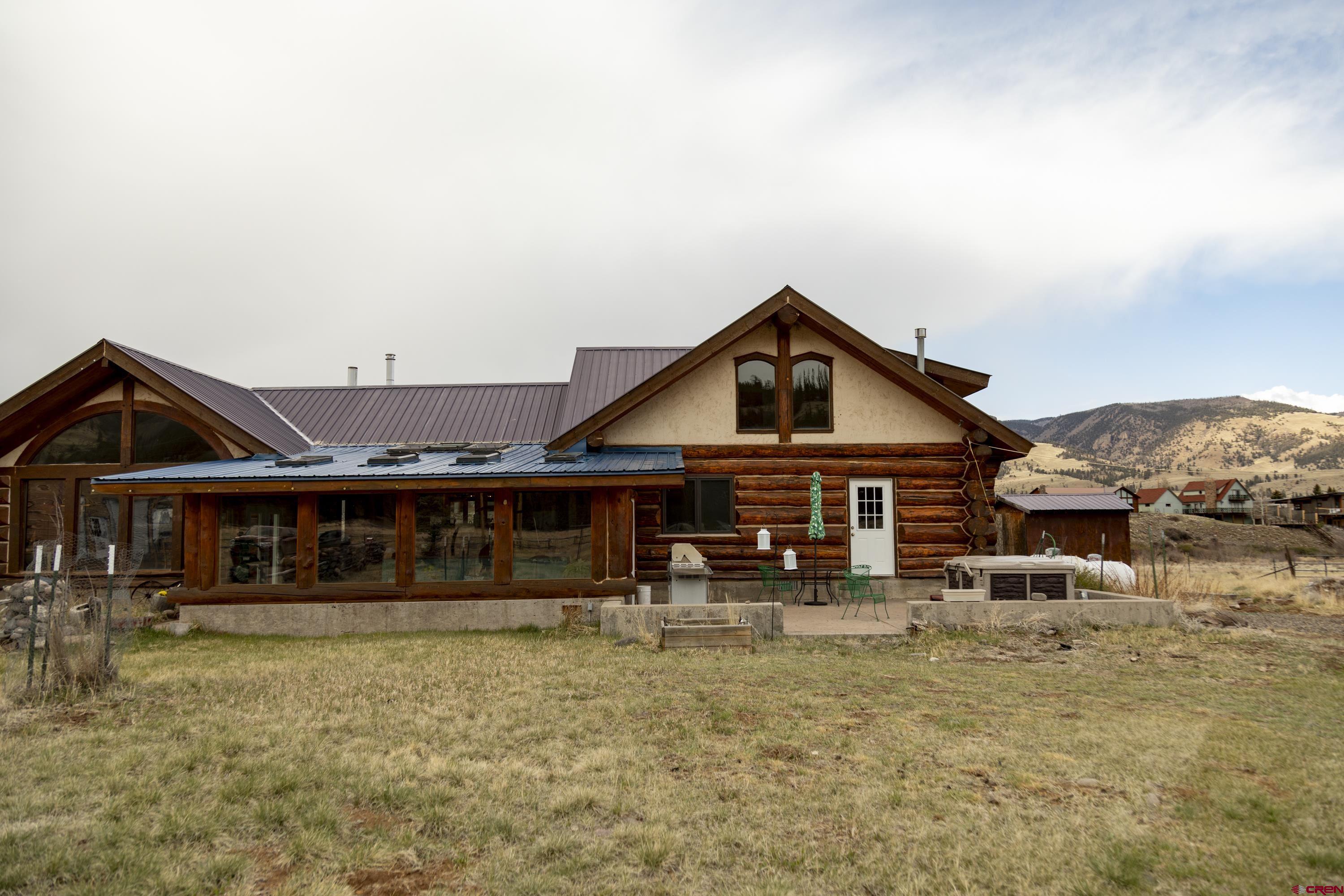 108 Forest Road Creede, CO 81130 - Photo 29 of 32 a view of a house with large windows and a big yard