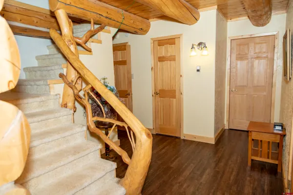 a view of entryway and hall with wooden floor