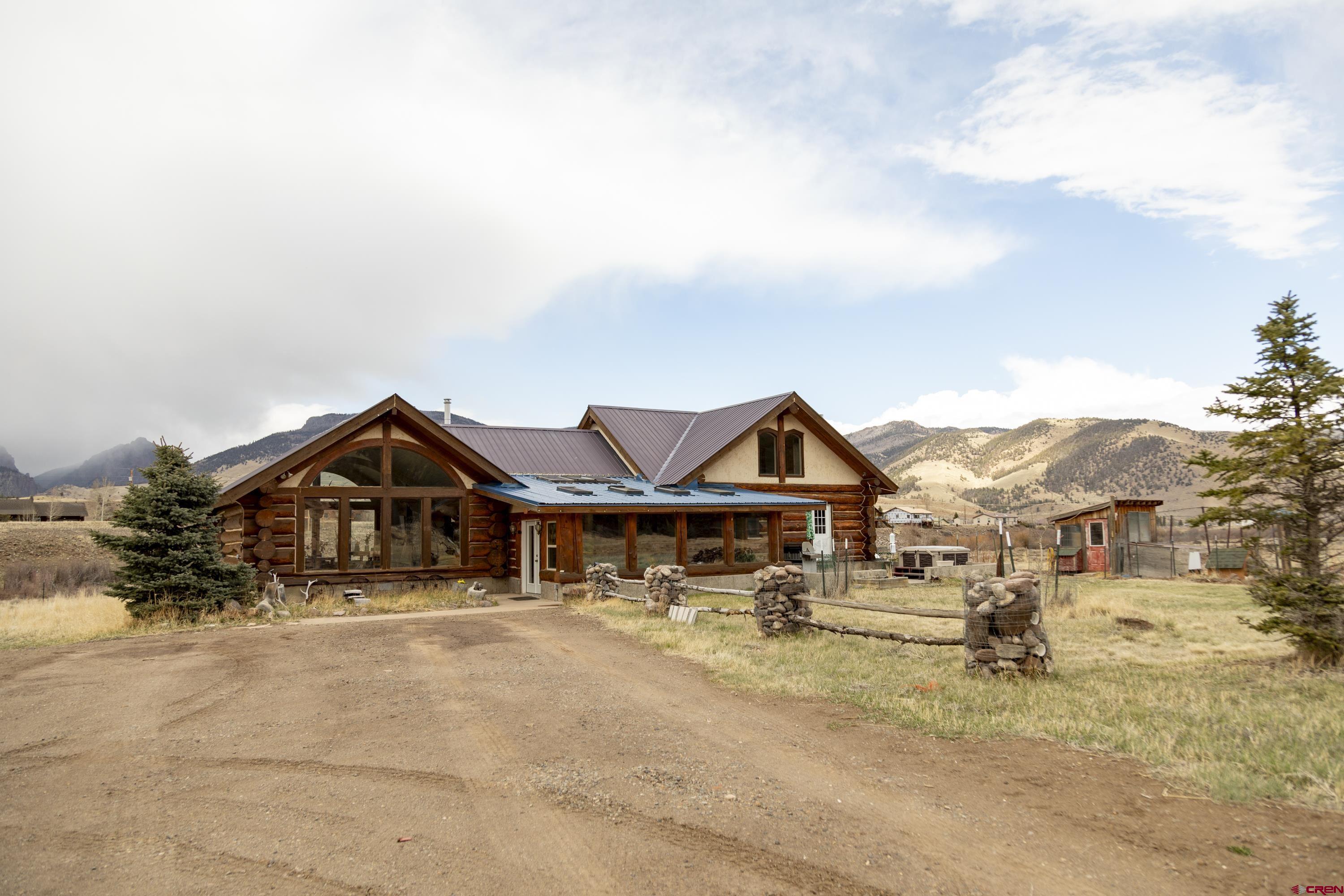 108 Forest Road Creede, CO 81130 - Photo 3 of 32 a view of a big house with a fountain and yard