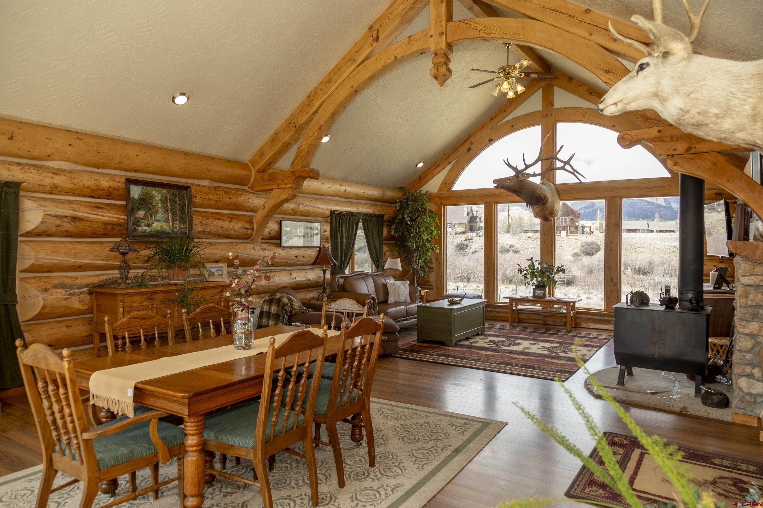 108 Forest Road Creede, CO 81130 - Photo 4 of 32 a dining room with furniture a chandelier and wooden floor