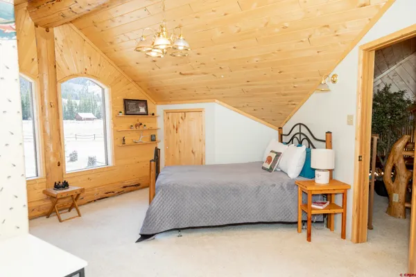 a bedroom with a bed and ceiling fan