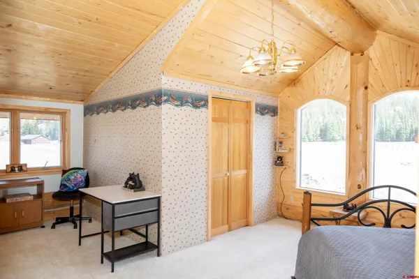 a bedroom with furniture and a window