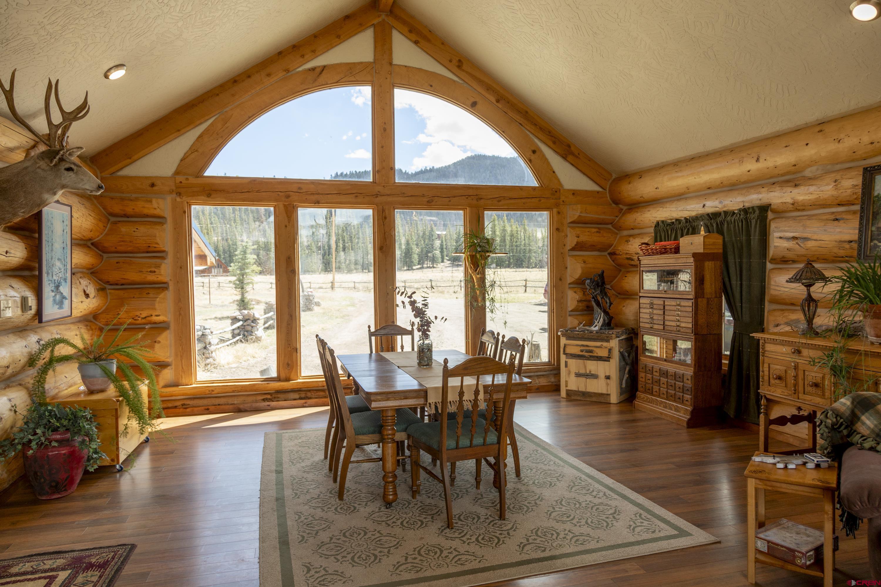 108 Forest Road Creede, CO 81130 - Photo 6 of 32 a view of a dining room with furniture window and wooden floor