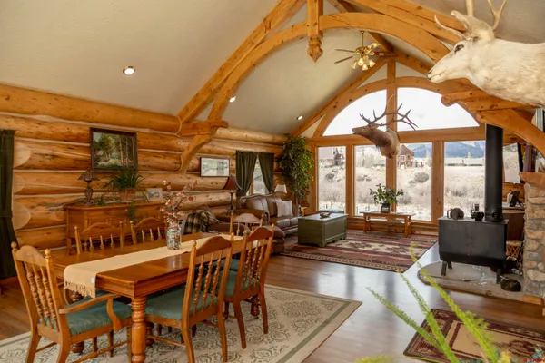 a dining room with furniture a chandelier and wooden floor