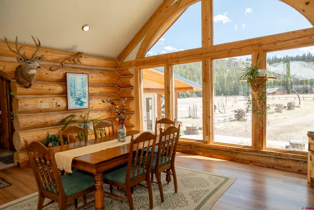 a dining room with furniture and wooden floor