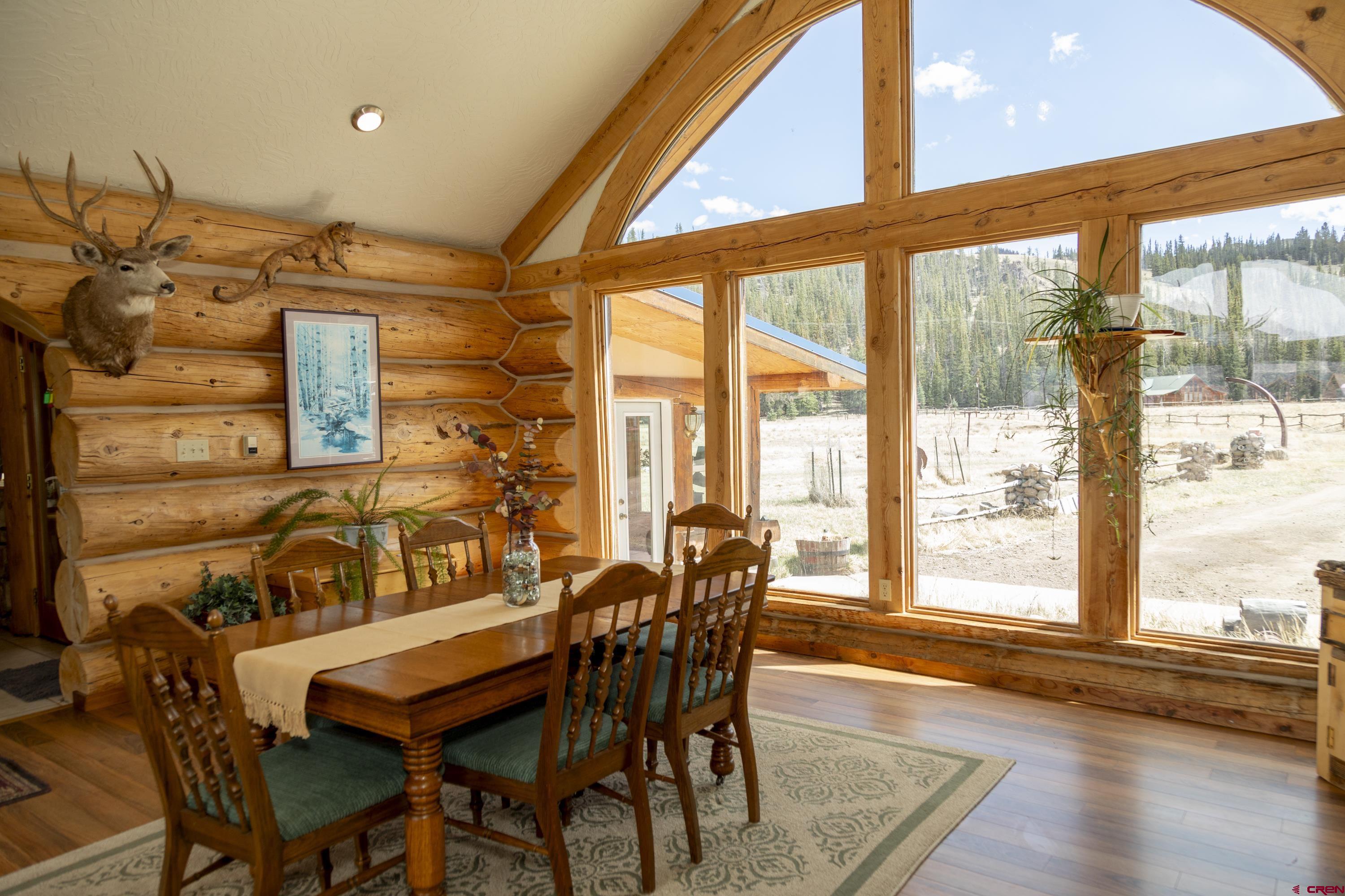 108 Forest Road Creede, CO 81130 - Photo 9 of 32 a dining room with furniture and wooden floor