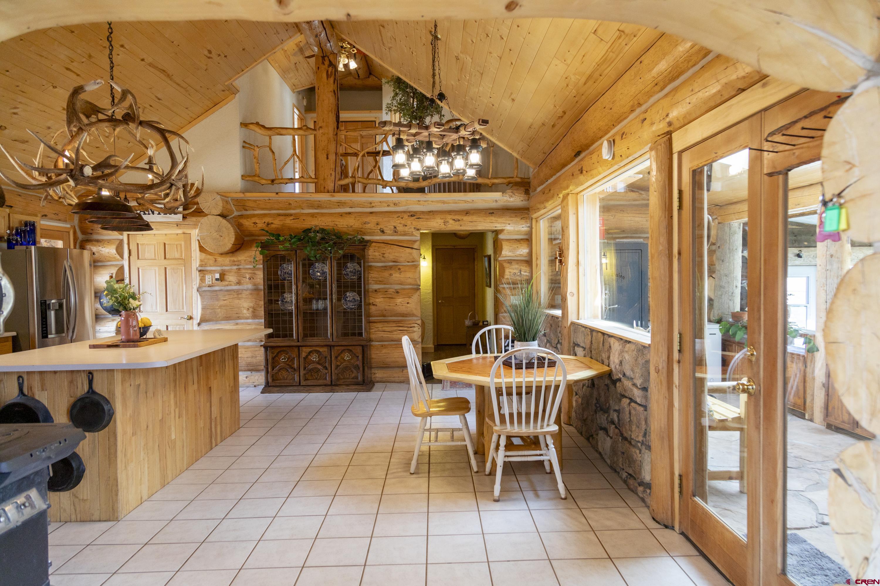 108 Forest Road Creede, CO 81130 - Photo 10 of 32 a dining room with furniture and a chandelier